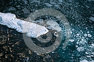 Blue sea surface with thin ice texture and snow