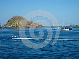 Blue sea view with an island and some white boats