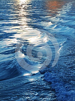 Blue sea water waves sunset from ship wake