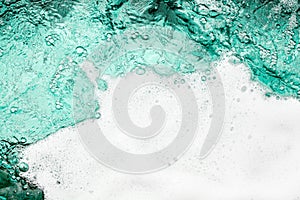 Blue sea water white foam texture background closeup, foamy ocean wave pattern, aqua bubbles surface, swimming pool backdrop