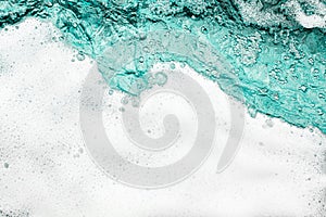 Blue sea water white foam texture background closeup, foamy ocean wave pattern, aqua bubbles surface, swimming pool backdrop