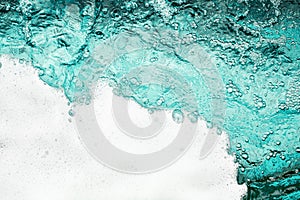 Blue sea water white foam texture background closeup, foamy ocean wave pattern, aqua bubbles surface, swimming pool backdrop