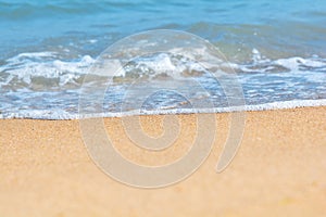 Blue sea wave on sandy beach. Travel background. Soft focus