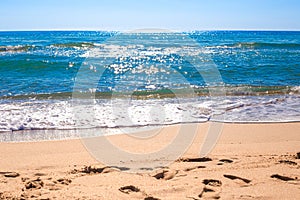 Blue sea with a wave and sandy shore. Natural background of nature, seascape