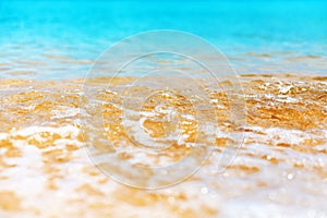 Blue sea wave texture close up, turquoise ocean, transparent water surface, white foam, golden yellow sand, tropical island beach