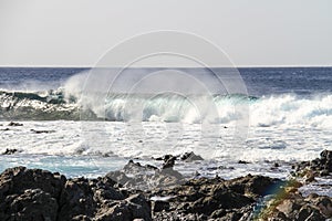 blue sea waves crashing against the rocks, big blue wave in the ocean