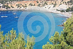 The blue sea of â€‹â€‹ibiza in summer and its bright colors between water and beaches in the coves