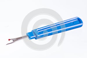 Blue seam ripper isolated on white photo