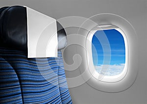 Blue seat beside window plane