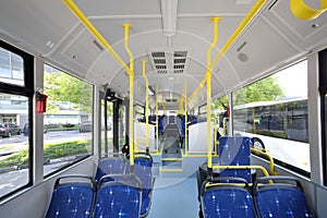 Blue seats inside saloon of empty city bus