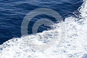 Blue Seawater with sea foam as background