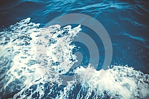 Blue Seawater with sea foam as background. Deep blue sea water with spray. Ocean water background