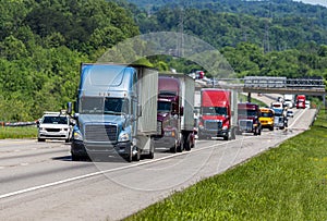 Blue Semi climbs Interstate Hill In Heavy Traffic