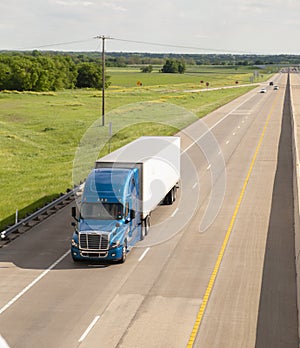 Blue Semi Truck Trailer Rig Hauls Freight on Divided Highway