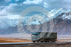 Blue Semitrailer Truck on an Empty Road with Snow-capped Mountains in the Distance
