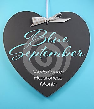 Blue September for mens health awareness month message greeting on heart shape blackboard