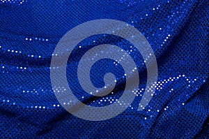 Blue sequined draped fabric background