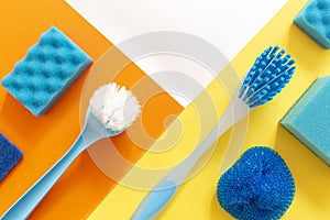 Blue set of cleaning tools on the colorfut backgrounds with geometric copy space.