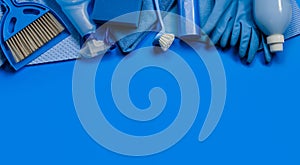 Blue set of tools and cleaning tools for spring cleaning in the house on a blue background.