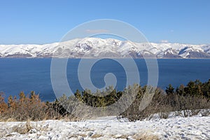 Blue Sevan lake and beautiful snowy mountains at photo