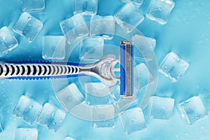 Blue shaving machine with sharp blades on the background of ice cubes close-up