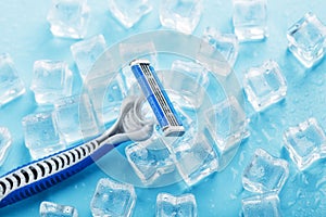 Blue shaving machine with sharp blades on the background of ice cubes close-up