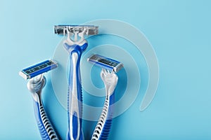 Blue shaving machines in a row on a blue background