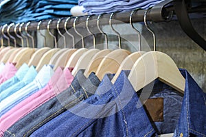 Blue shirt shop, through new clothes during shopping, Colorful man in a retail shop. Fashion and shopping business concept. jeans