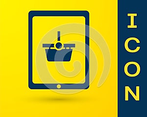 Blue Shopping basket on screen tablet icon isolated on yellow background. Concept e-commerce, e-business, online