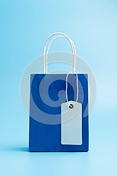 Blue shopping or gift bag isolated on blue background