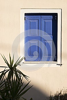 A blue shuttered window