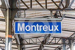 Blue sign indicating the name of a train stop in Montreux