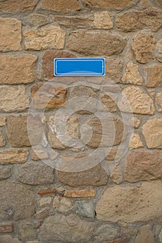 Blue sign on stone wall