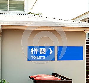 A blue sign for toilets and restrooms