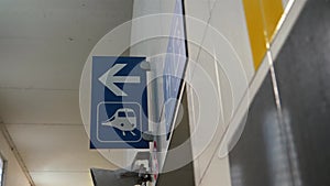 Blue sign in train station pointing to train platforms