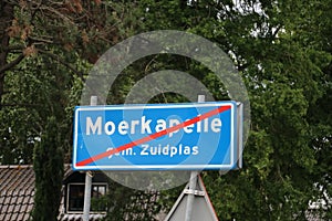 Blue sign with white text and red stripe to indicate that the end of the urban up area is of Moerkapelle municipality Zuidplas in