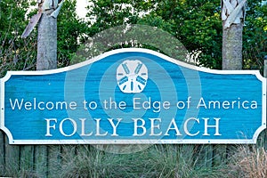 Blue signpost "Welcome sign for Folly Beach, SC which is just south of Charleston South Carolina USA