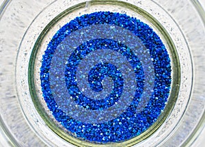 Blue silica gel in desiccator background.