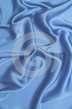 Blue silk or satin luxury fabric texture. Top view