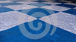 Blue and silver checkered flooring with an abstract pattern