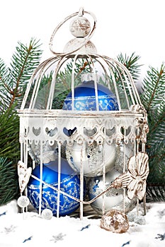 Blue and silver christmas balls in cage