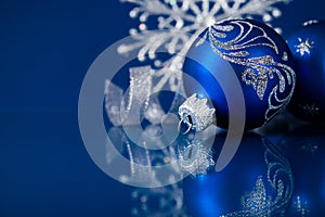 Blue and silver christmas ornaments on dark blue background