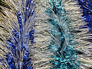 Blue silver decorations on the Christmas tree of the holiday close-up