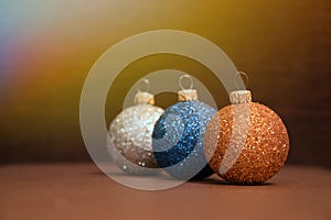 Blue, silver,golden Christmas balls are in line with sunlight