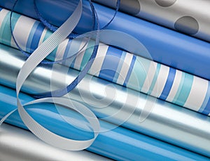 Blue, silver and while wrapping paper gift wrap and ribbons for Hanukkah holiday gifts presents