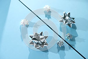 Blue and silver xmas ornaments on bright holiday background with space for text.