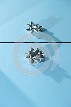 Blue and silver xmas ornaments on bright holiday background with space for text
