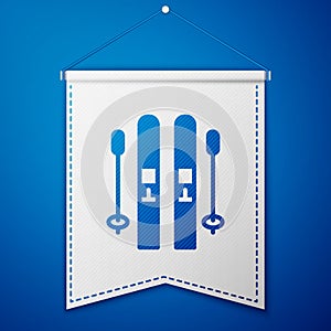 Blue Ski and sticks icon isolated on blue background. Extreme sport. Skiing equipment. Winter sports icon. White pennant