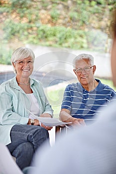 Blue skies ahead. Over-the-shoulder shot of a financial advisor meeting with a senior couple at their home.