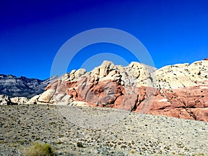 Blue skies with red rock mountains